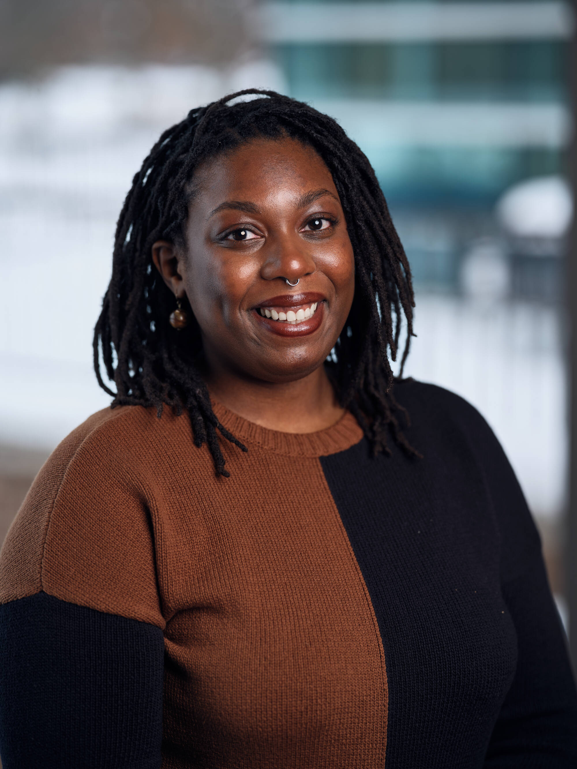 An individual smiling at the camera.